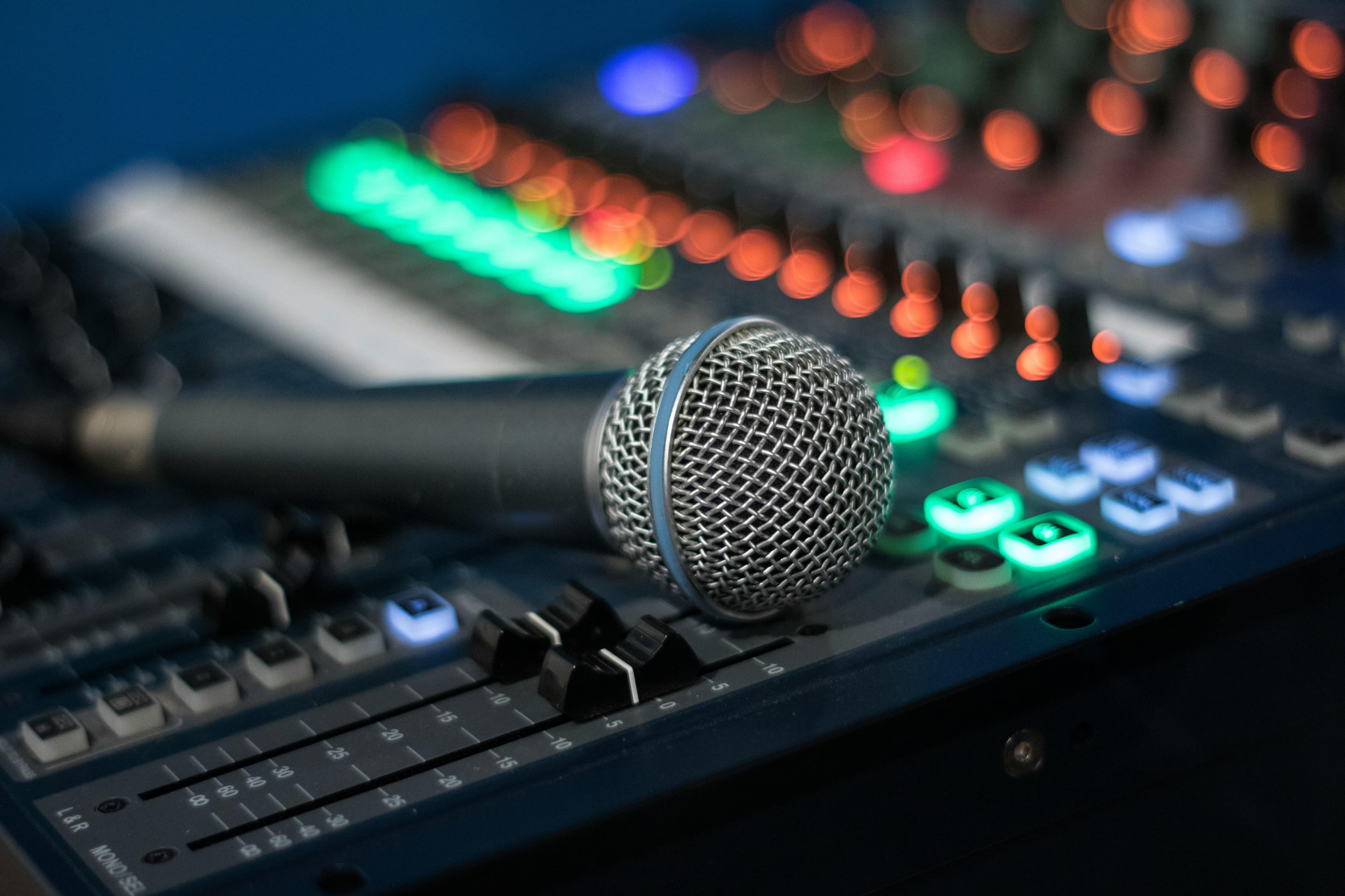 Microphone on an audio mixing desk at a speaking event